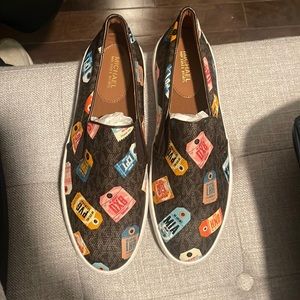 Brand new Michael Kors Keaton slip on with airport tags logo